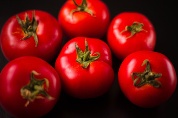 Tomatoes on a black background