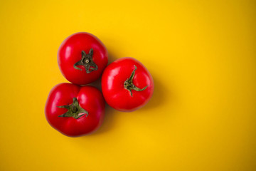 Tomatoes on a yellow background