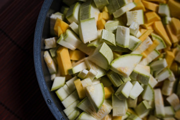 sliced zucchini with potatoes in a frying pan