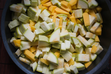 sliced zucchini with potatoes in a frying pan