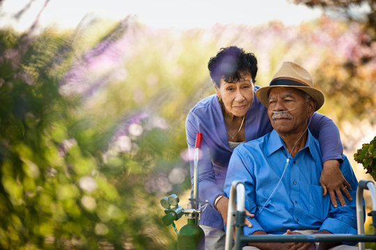 Senior woman hugging her husband with nasal tubes. - Powered by Adobe