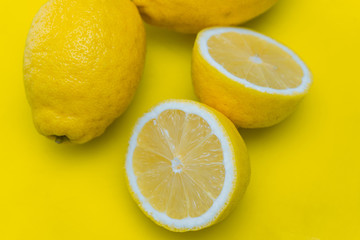 Close-up of cut lemons on yellow cutting board
