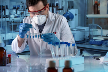 geneticist holding pcr tubes for genetic analytical in the clinical laboratory