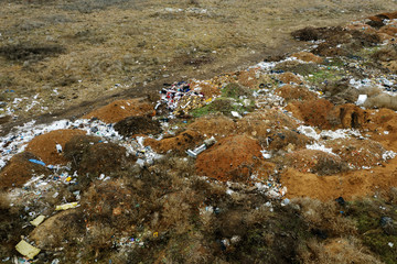 Fototapeta na wymiar Aerial top view of a large pile of garbage. Pile of garbage on an illegal elemental garbage dump or on landfill, Many household waste plastic bags in front of house. Landfill, environmental waste