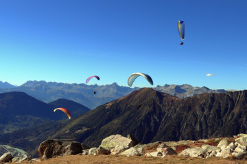 Paragliders soaring the deep blue sky. Autumn in the French Alps, Chamonix-Mont-Blanc, Haute-Savoie, France.