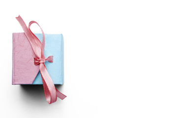 Pink and blue jewelry box with a pink ribbon on a white background. Copy space