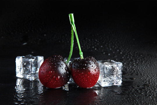 cherry frozen in ice on black background