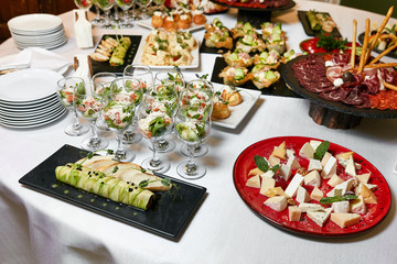 dishes on the table, salads in glasses, snacks, reception