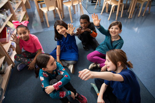 Students sitting on floor in classroom