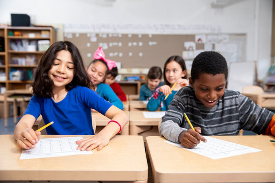 Students smiling while taking test in class