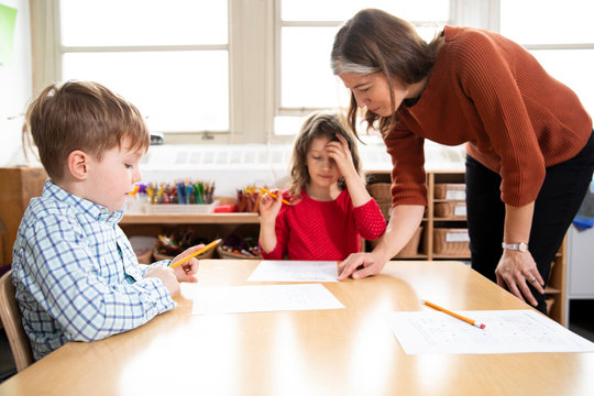 Teacher helping students