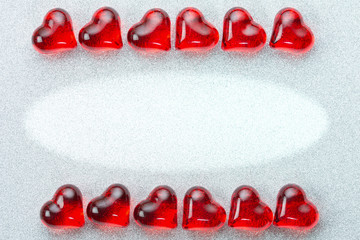 Valentine, wedding card background with two rows of shiny hearts lying on their sides on a silver brocade background