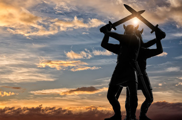 Two Vikings, standing back to back and swinging their swords, bright sun, blue sky with yellow-white clouds in the background, Old Norse epic, Valhalla theme - obrazy, fototapety, plakaty