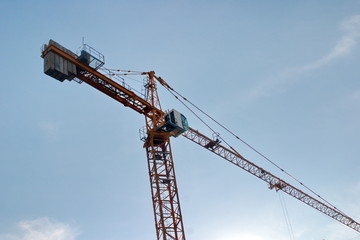 Image of a working construction crane on a blue sky background