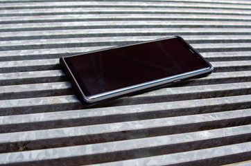cell phone on metal grid