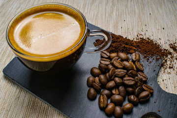 cup of espresso coffee and coffee beans