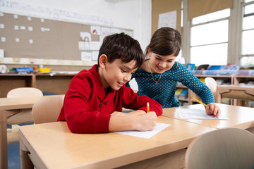 Boy and girl smiling in classroom