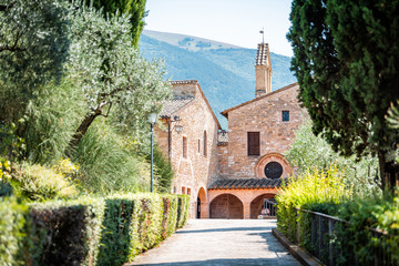 Assisi, Italy town or village city in Umbria with San Damiano church during sunny summer day and road path with nobody
