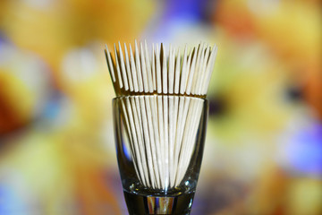 Wooden toothpicks on a multicolor background
