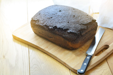 A loaf of rye bread on a wooden cutting board