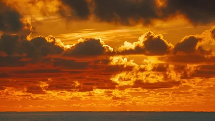 Epic sunrise clouds over orange sky and ocean in Miami, Florida. 4K UHD Timelapse.