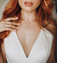 Tender lips and skin of charming bride with red curly hair