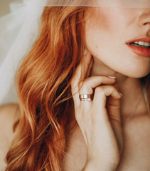 Tender lips and skin of charming bride with red curly hair