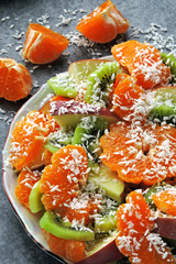 Healthy fruit salad with mandarin and kiwi. Tropical Salad.
