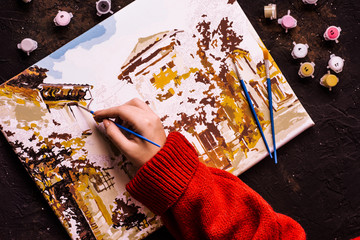 Picture by numbers. Drawing on canvas. Woman's hand with brush. Numbered paint cans. Creative hobby. Painting for beginners. Novice artist. Art idea. Painting on black background. Relax time