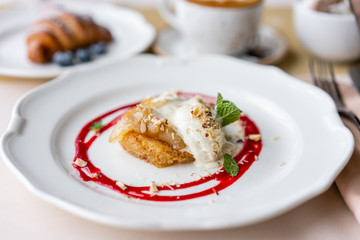 French toast style brioche with vanilla ice cream, pear, nut, mint leaf and red berry sauce. Light morning Breakfast, fresh warm pastries and aromatic cappuccino coffee