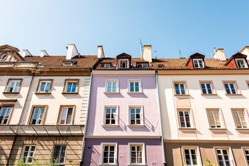 Fototapeta premium Warsaw, Poland old town market square with historic street town architecture and windows closeup pattern of pink and yellow vintage color