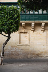 Detail shot of the stonework and balcony in Piazza Regina, Malta