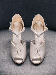 Pair of silver female high heeled wedding shoes