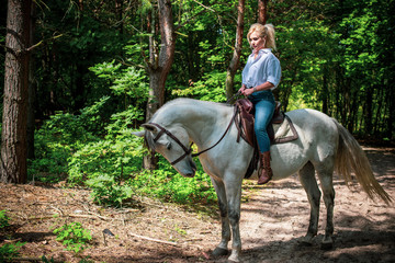 Spring - summer season, concept of hobby, Woman with a horse on a nature, relationship human and animals