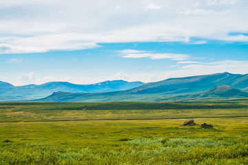 Spectacular view of giant mountains under cloudy sky. Huge mountain range at overcast weather. Wonderful wild scenery. Atmospheric highland landscape of majestic nature. Scenic mountainscape.