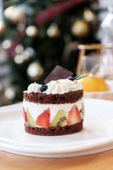 Chocolate cake with whip cream and fruit. .