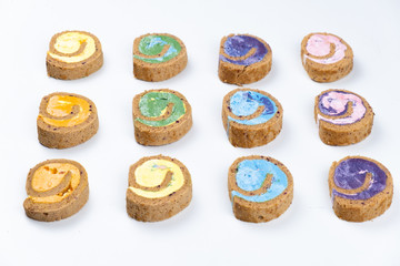 Delicious creamy colourful minimal cake roll on white background.