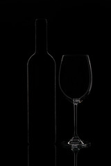 Silhouette of wine bottle and wine glass, objects on black background
