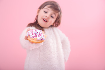 Portrait of a little girl with a donut in her hands