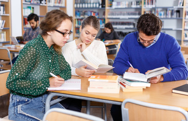 Young adults working in public library