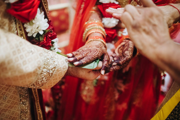 Ritual with coconut leaves during traditional Hindu wedding ceremony