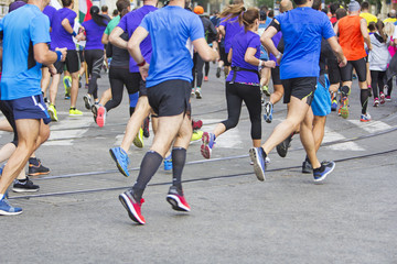 Marathon runners running race people feet on city road