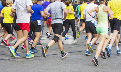 Fototapeta na wymiar Marathon runners running race people feet on city road