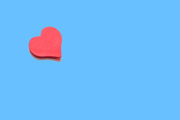 Small red heart glued to the mirror. Abstract background. Concept: love, tenderness, valentine's day.