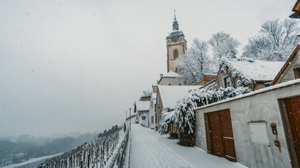  Snow in the city. Renaissance Chateau and Church of St. Peter and Paul, Labe river, Melnik, Czech Republic. Stunnig winter landscape.