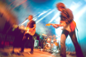  Live music and rock band on stage.Abstract musical background. Playing guitar and music concert...
