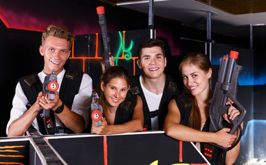 Young people posing with laser pistols