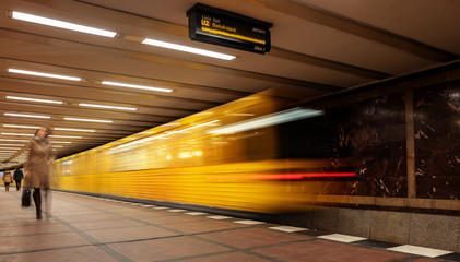 Berlin subway moving train with passengers on the platform, Germany - obrazy, fototapety, plakaty