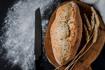Freshly baked homemade traditional bread on rustic wooden table