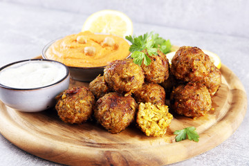 Traditional homemade hummus, falafel and chickpea served with spices on table. Jewish Cuisine.
